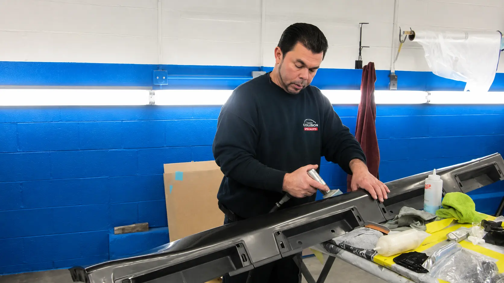Chalkstone Auto Body technician refinishing a metal vehicle panel