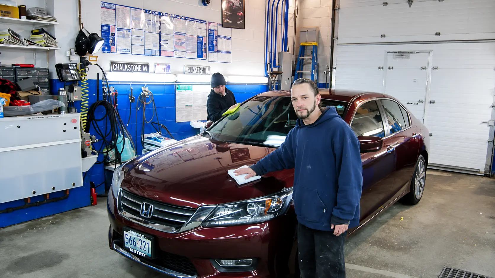 Final detailing of a repaired Honda sedan